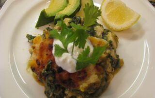 Chicken enchilada with spinach and sour cream.